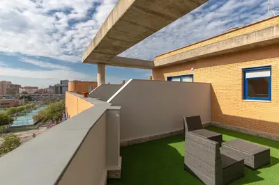 a balcony with two chairs and green grass at Albergue Juvenil Colegio Mayor Galileo Galilei in Valencia