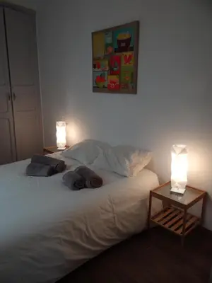 a bedroom with a bed with two lamps on it at Valencia what else... in Valencia