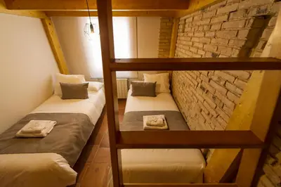 two bunk beds in a room with a brick wall at MD Sueca in Valencia