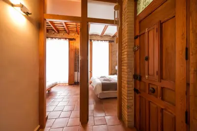 a bedroom with a bed and a door in a room at MD Sueca in Valencia