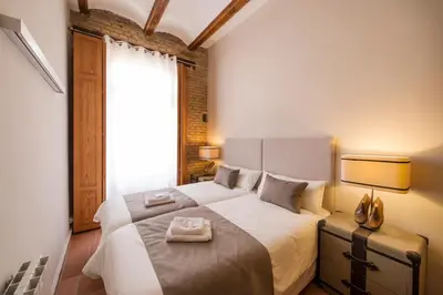 a bedroom with a large bed with two towels on it at MD Sueca in Valencia
