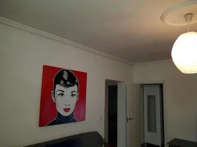 a painting of a woman on a wall at Apartamento Sofia in Valencia