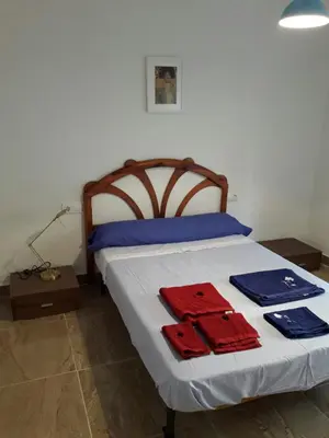 a bedroom with a bed with blue and red towels on it at Apartamento Sofia in Valencia