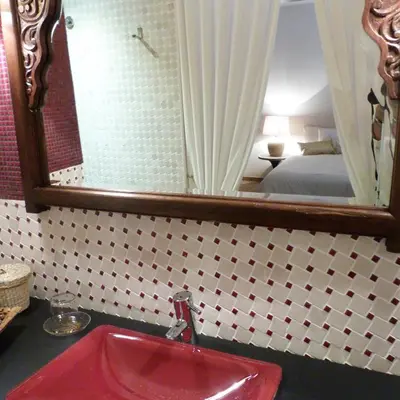 a bathroom with a red sink and a mirror at Dalt Vila in Eslida
