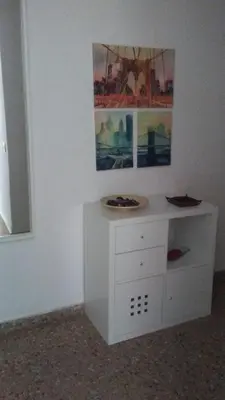 a white desk in a room with a painting on the wall at Apartamento a 10 metros del mar in Cullera
