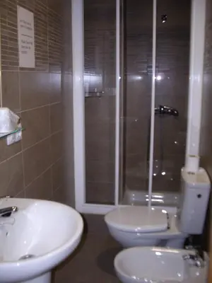 a bathroom with a toilet and a sink and a shower at Hostal Abastos in Valencia