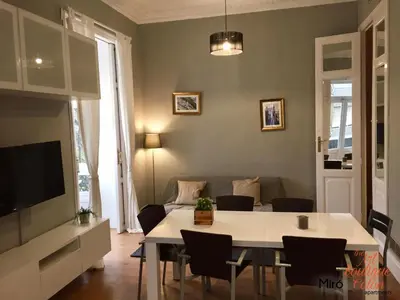a living room with a table and a couch at The Art Boutique Colon in Valencia