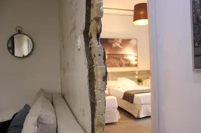 a living room with a couch and a bedroom at The Art Boutique Colon in Valencia