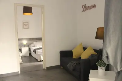 a living room with a couch and a bedroom at The Art Boutique Colon in Valencia