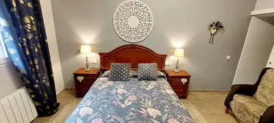 a bedroom with a bed and two lamps and a couch at Ca Emma in Mahuella