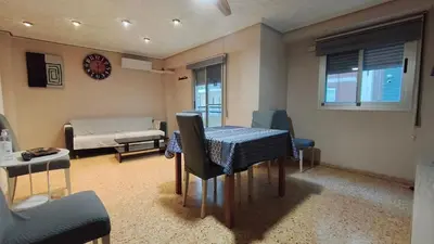 a living room with a table and chairs and a couch at Piso Colon in Paiporta