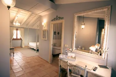 a bathroom with a mirror and a sink and a tub at La Mozaira in Alboraya