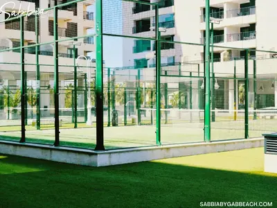 a view of a tennis court through a window at Sabbia Valencia Apartment in Valencia
