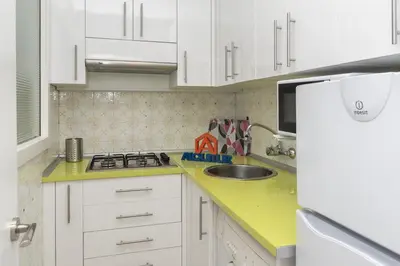 a small kitchen with white cabinets and a sink at Apolo, 3º-16 in Cullera