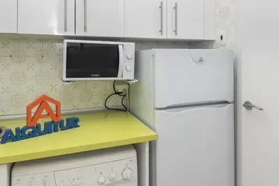 a kitchen with a white refrigerator and a microwave at Apolo, 3º-16 in Cullera