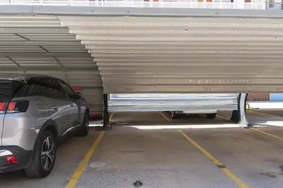 a parking garage with a car parked under a ramp at Apolo, 3º-16 in Cullera