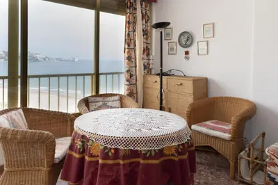 a room with a table and chairs and a balcony at Arensol Esc-A, 13º-51 in Cullera