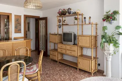 a living room with a tv and a table at Arensol Esc-A, 13º-51 in Cullera