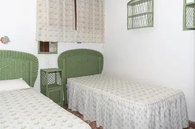 a room with two green beds and two windows at Arensol Esc-A, 13º-51 in Cullera