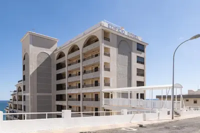 a large building with a street light in front of it at Dosel, 6º-30 in Cullera