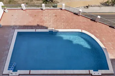 an overhead view of a large swimming pool on a building at Dosel, 6º-30 in Cullera