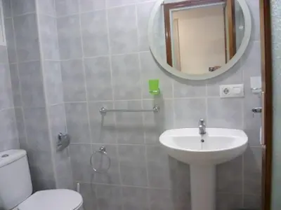 a bathroom with a sink and a toilet and a mirror at Estirpe, 2º-3 in Cullera