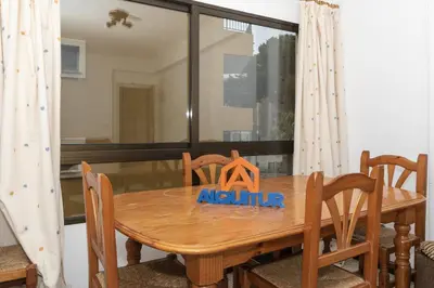 a wooden dining room table with aania sign on it at Estirpe, 2º-4 in Cullera