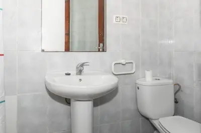 a bathroom with a sink and a toilet and a mirror at Estirpe, 2º-4 in Cullera