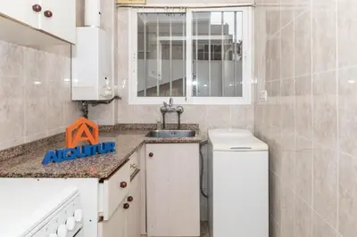 a small kitchen with a sink and a mirror at Estirpe, 2º-4 in Cullera