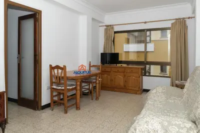 a living room with a dining room table and a couch at Estirpe, 4º-8 in Cullera