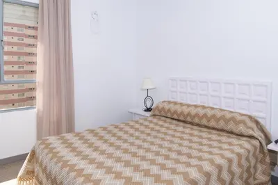 a bedroom with a bed and a window at Estrella, 6º-36 in Cullera