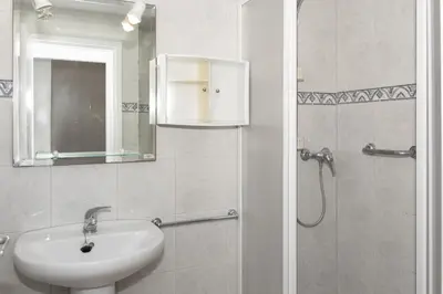 a bathroom with a sink and a shower with a mirror at Estrella, 6º-36 in Cullera