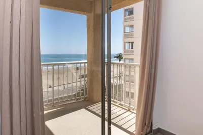 a room with a balcony with a view of the beach at Estrella, 6º-36 in Cullera