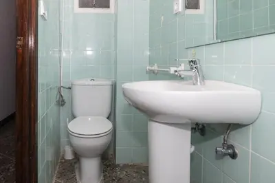a bathroom with a toilet and a sink at Europa B 6º-23 in Cullera