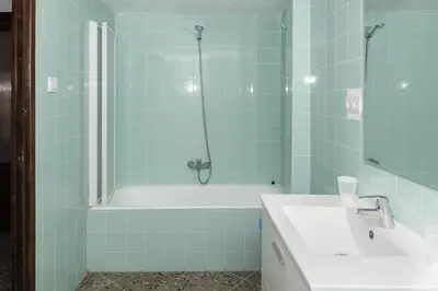 a bathroom with a tub and a sink and a shower at Europa B 6º-23 in Cullera