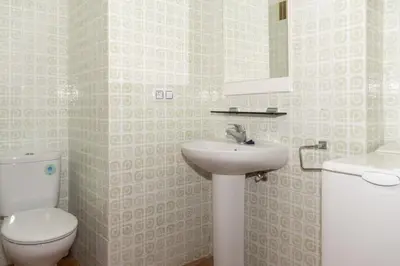 a bathroom with a toilet and a sink at Florazar 1, I-A 7-B in Cullera