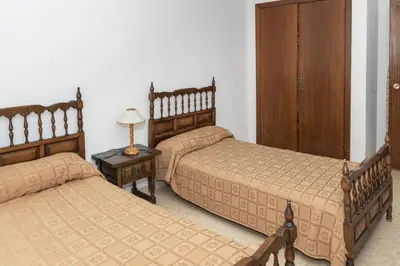 a bedroom with two beds and a table with a lamp at Florazar 1, Iii-A 18-C in Cullera