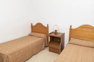 a bedroom with two beds and a table with a lamp at Florazar 1, Iii-A 18-C in Cullera