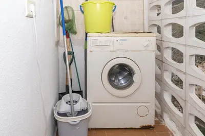 a washing machine with a bucket on top of it at Florazar 1, Iii-A 18-C in Cullera