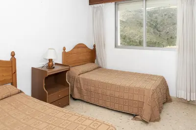 a hotel room with two beds and a window at Florazar 1, Iii-A 18-C in Cullera