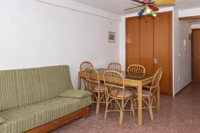 a living room with a couch and a table and chairs at Florazar 2, Iv-14-C in Cullera