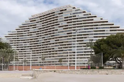 a large white building with trees in front of it at Florazar 2, Iv-14-C in Cullera