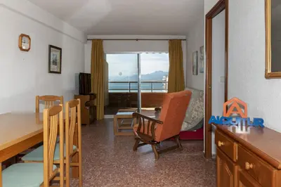 a room with a table and chairs and a bedroom at Florazar 2, Ix-9-C in Cullera
