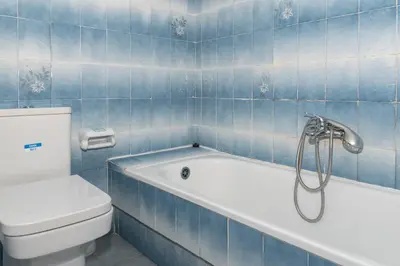 a blue tiled bathroom with a tub and a toilet at Florazar 2, Vi-10-B in Faro de Cullera