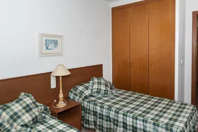 a hotel room with two beds and a lamp at Florazar 2, Vi-10-B in Faro de Cullera