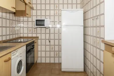 a kitchen with a white refrigerator and a microwave at Florazar 2, Vi-13-C in Faro de Cullera