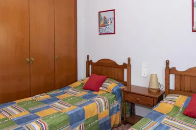 a bedroom with two twin beds and a night stand at Florazar 2, Vi-15-A in Cullera