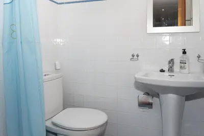 a white bathroom with a toilet and a sink at Florazar 2, Vi-15-A in Cullera