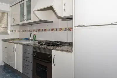 a white kitchen with a sink and a refrigerator at Florazar 2, Vi-15-A in Cullera