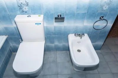 a bathroom with a toilet and a bidet and a sink at Florazar 2, Vi-1-B in Cullera